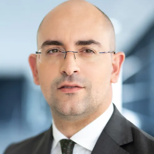 a man wearing glasses and a suit